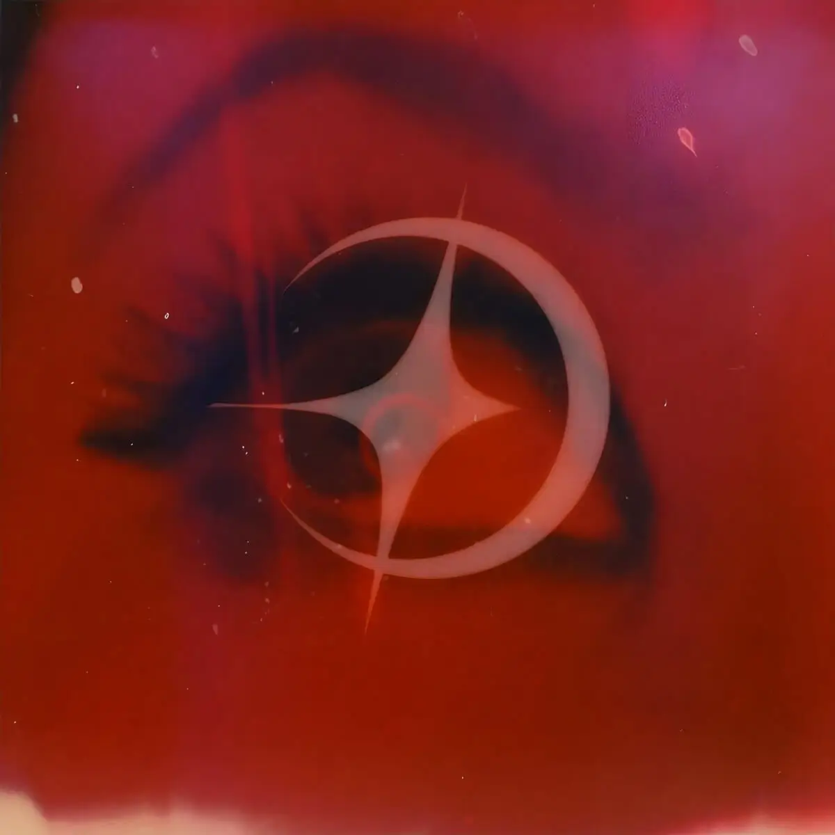 Cover art for The Ghost Aura’s single ‘Dominion’, featuring a stylised red-tinted eye overlaid with a glowing star and crescent shape.