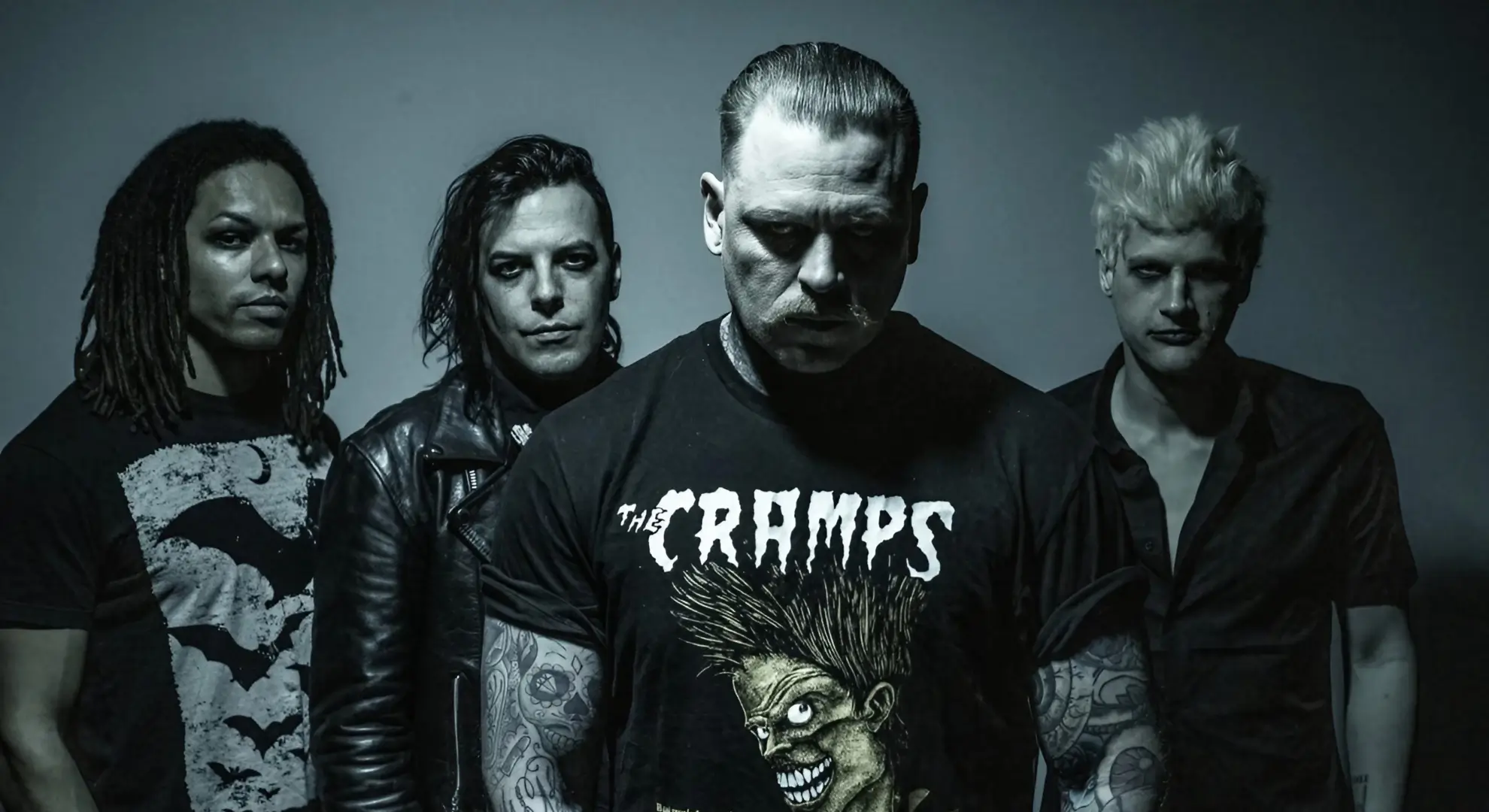 The four members of Combichrist pose for a desaturated studio photo.