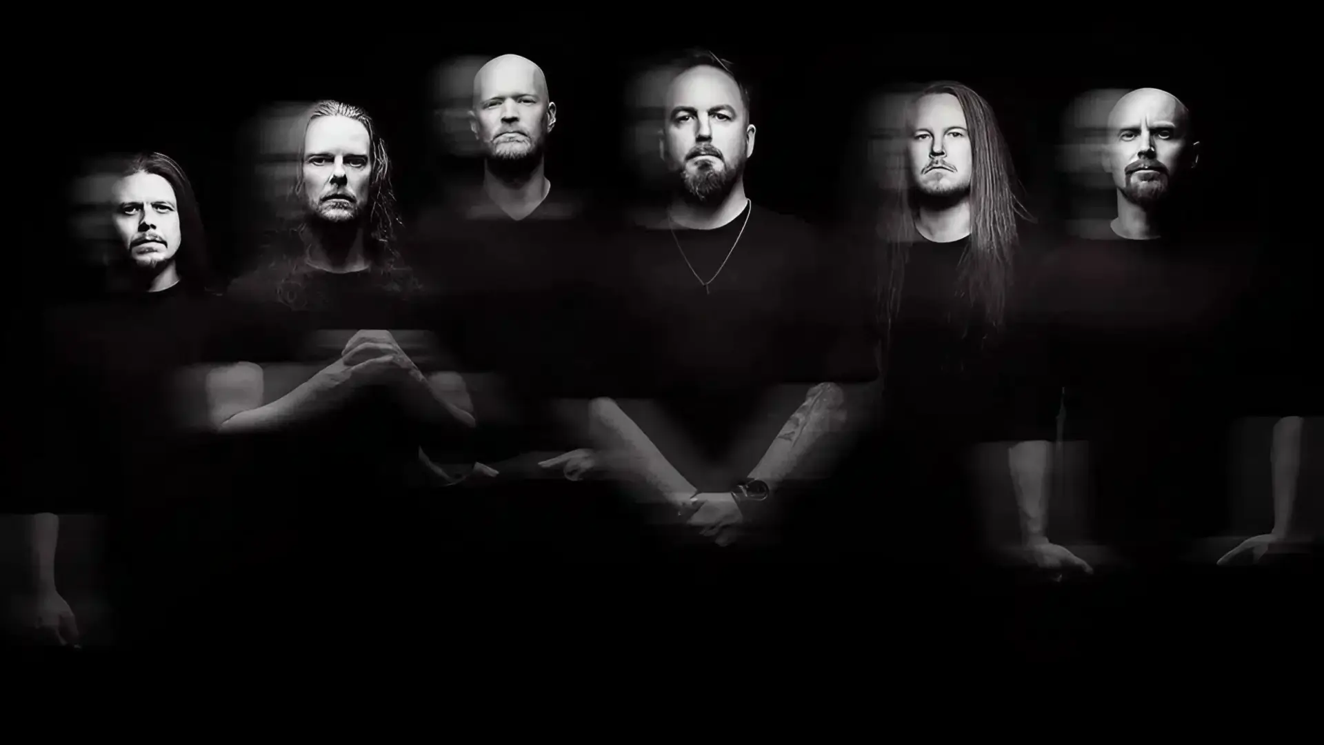 A black and white, motion-blurred photo of the six members of Bloodred Hourglass against a black background.
