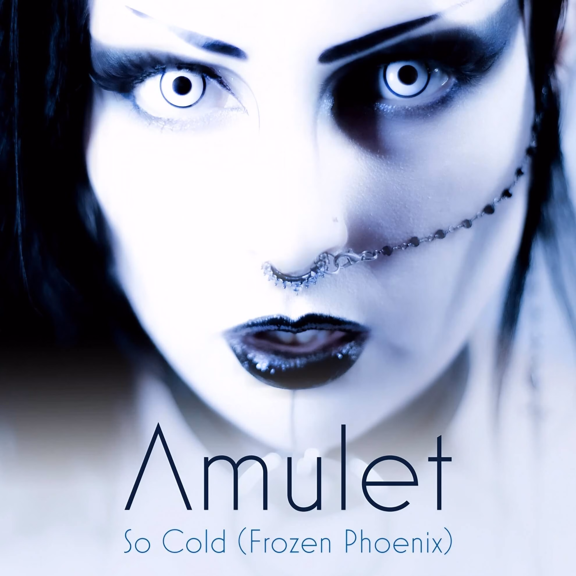 Cover art for Amulet&rsquo;s &lsquo;So Cold (Frozen Phoenix).&rsquo; A close-up of a face with white eyes, dark makeup, and a nose chain.