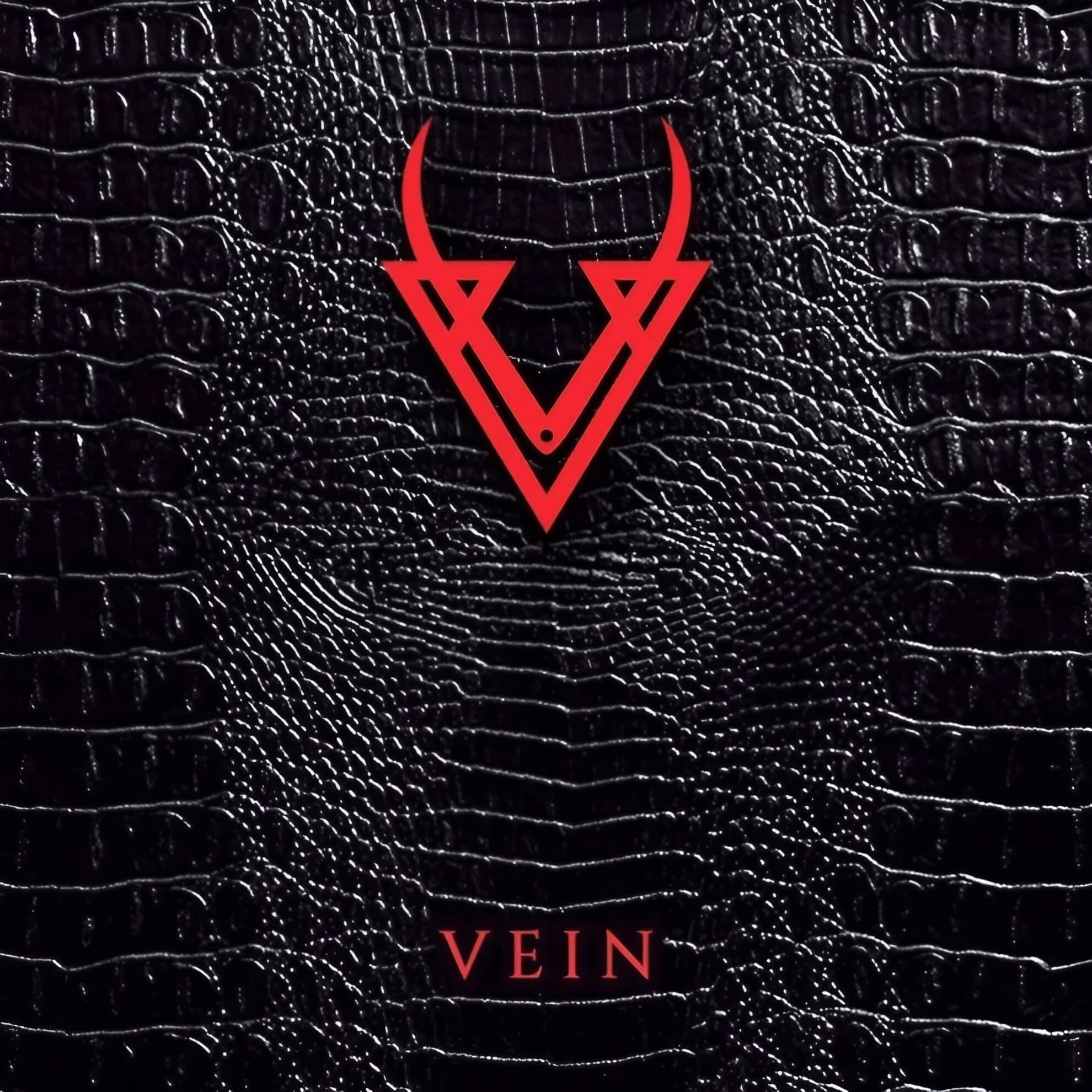 Vein: Bogotá’s Canvas of Cacophony and the Forthcoming Album ‘Reveal’ Album cover for ‘Chapter I.’ A red, horned “V” logo sits centered on a black, reptilian-skin-textured background.