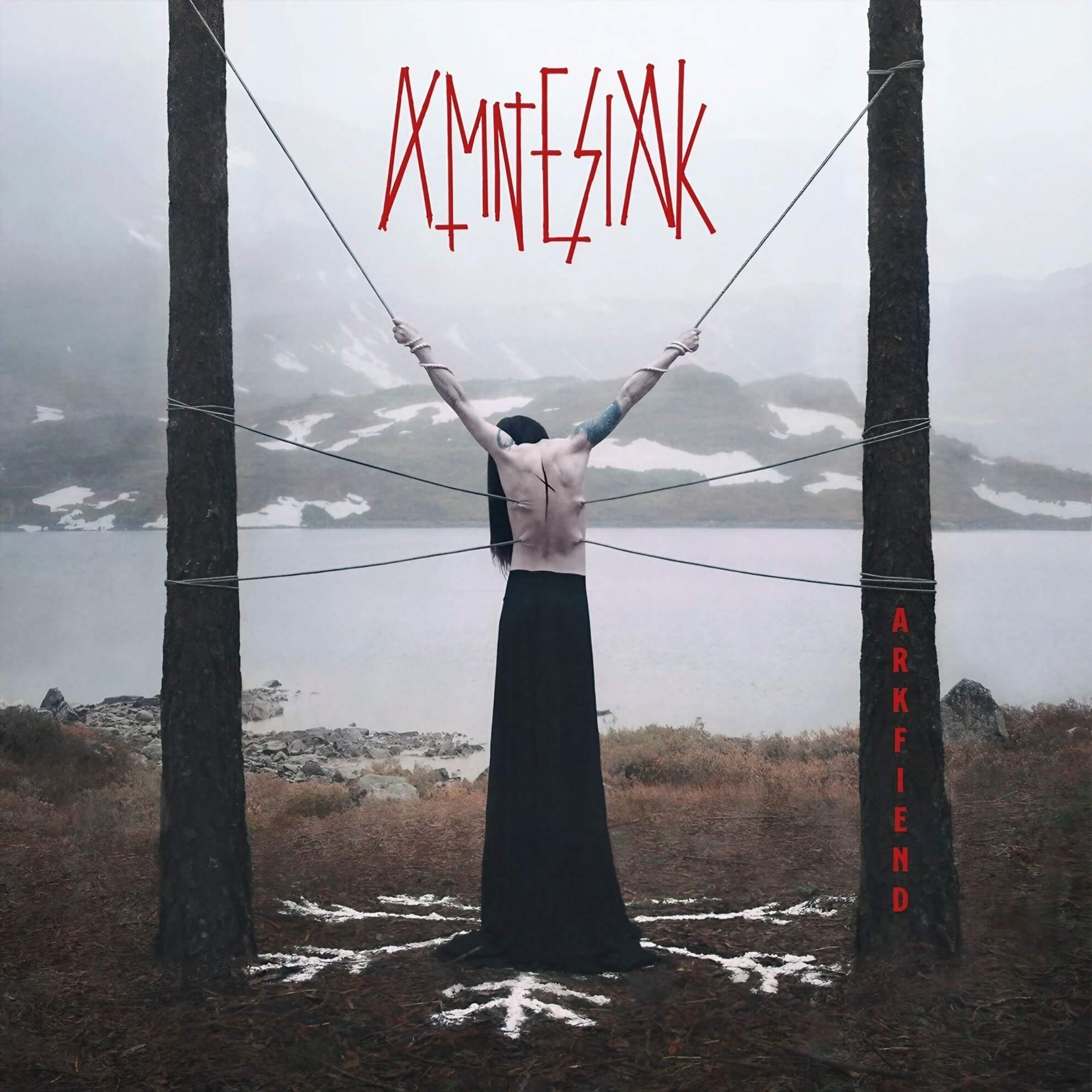 A pale figure stands bound between trees facing a misty lake. Red rune-like text floats above; a white sigil marks the ground below.