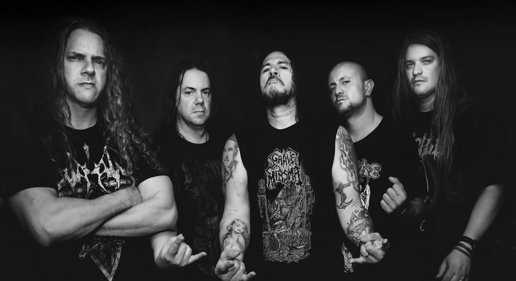 Masacre Channels the Echoes of Conflict on South America in 2026 A studio promotional portrait of Masacre. The band members stand in formation, wearing black clothing and projecting a serious, confrontational demeanor.