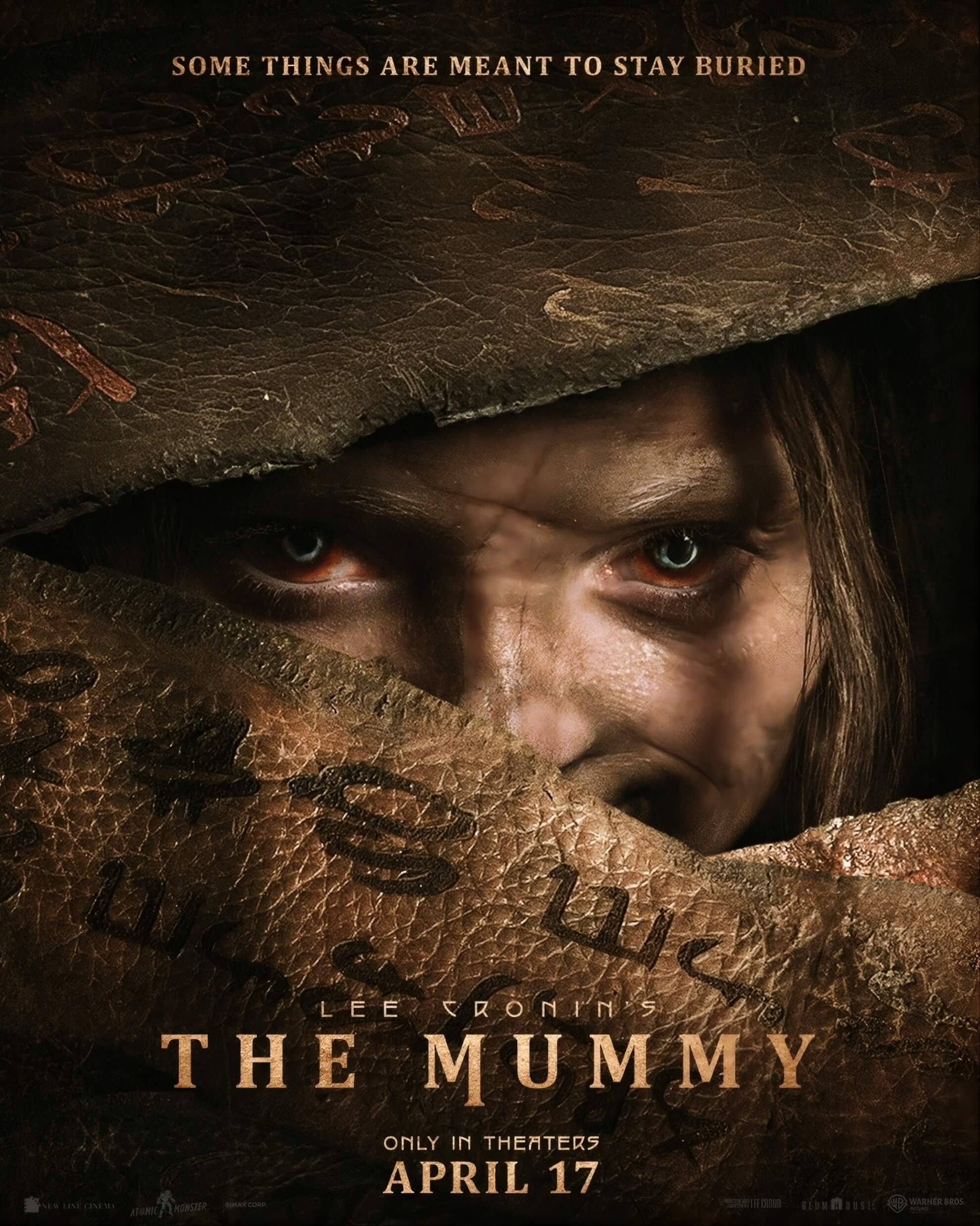 Natalie Grace as Katie Cannon tearing through ancient wrapping, blue eyes visible, hieroglyphs inscribed on cloth.