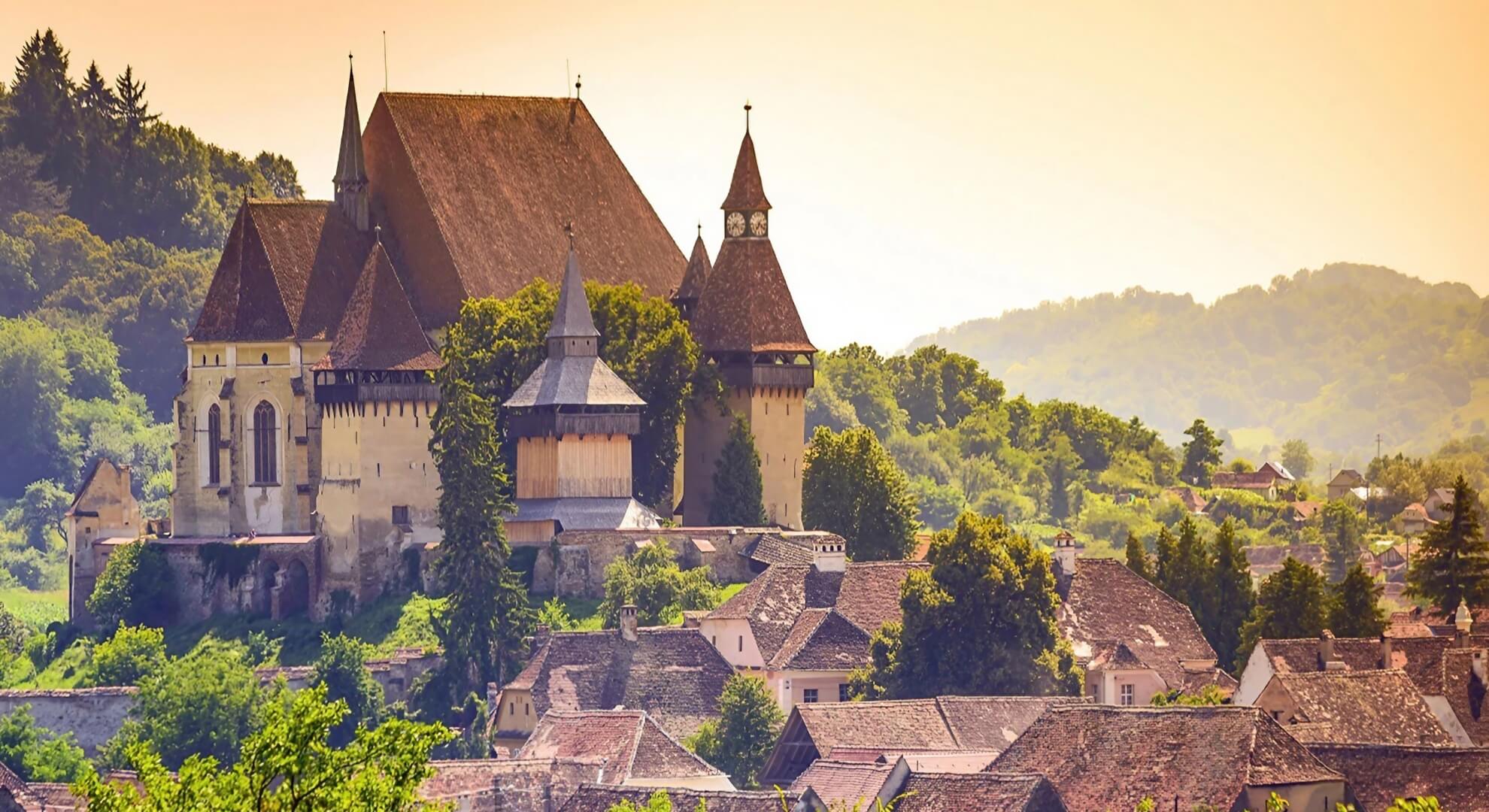 Biertan Fortified Church, Transylvania, Romania &mdash; multi-ring defensive complex with clock tower rising above the Saxon village below.