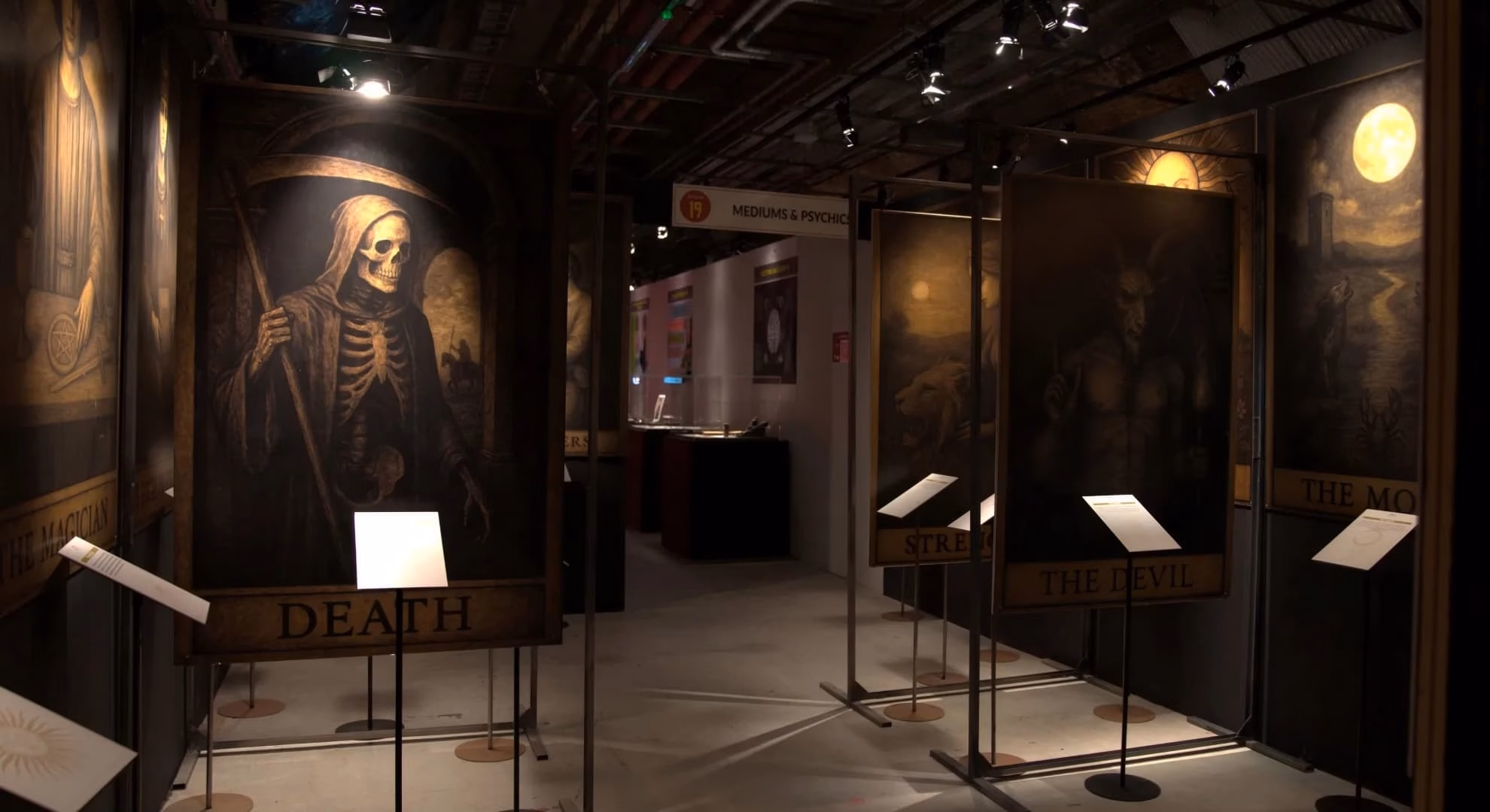 Installation view, ‘Dark Secrets,’ The Vaults, London — Thoth Tarot Death card reproduction panel among freestanding display stands.