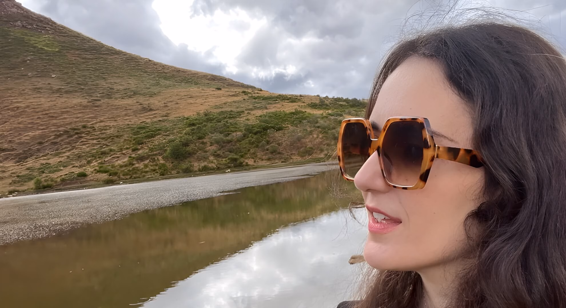 Maria J. P&eacute;rez Cuervo, Hellebore founder, profile with tortoiseshell sunglasses, Scottish hills behind.