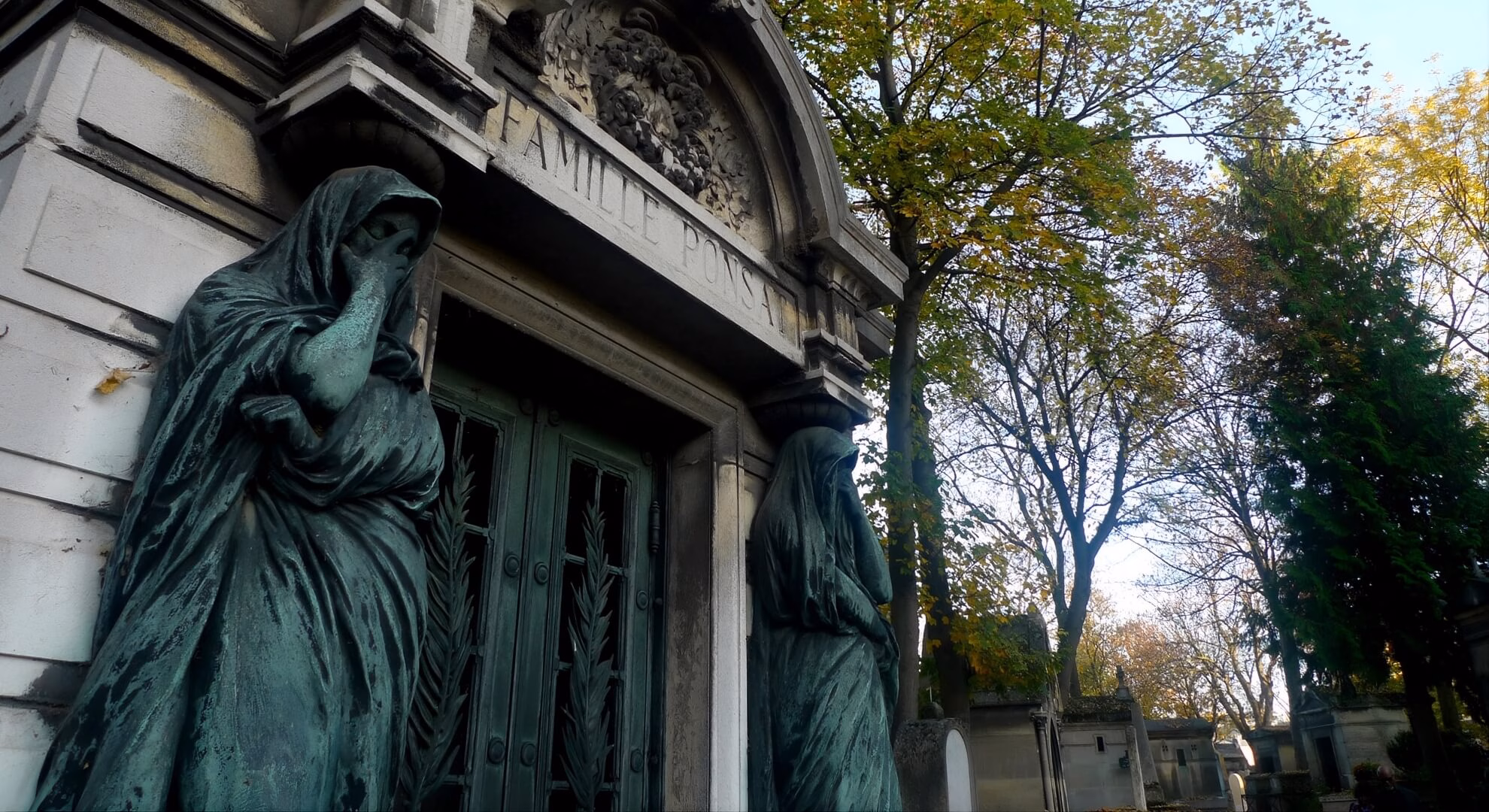 Two bronze veiled caryatids flanking the Famille Ponsat mausoleum entrance, P&egrave;re Lachaise Cemetery, Paris.