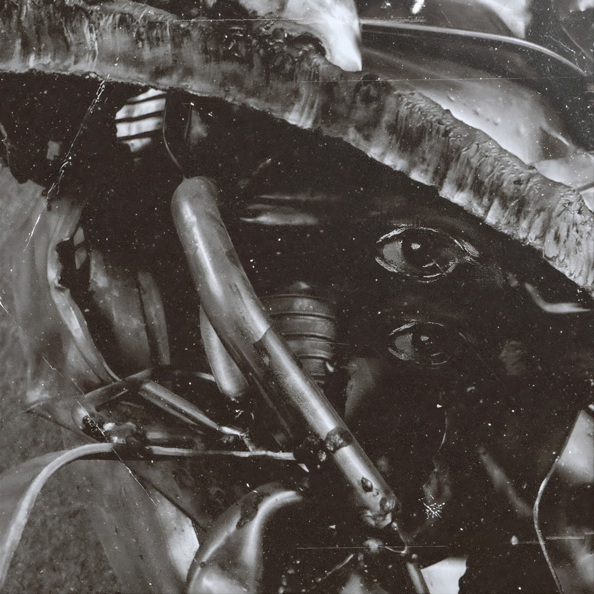 Emptiness ‘Nowhere Speaks’ album cover — a masked face half-submerged in organic metallic forms, in monochrome.
