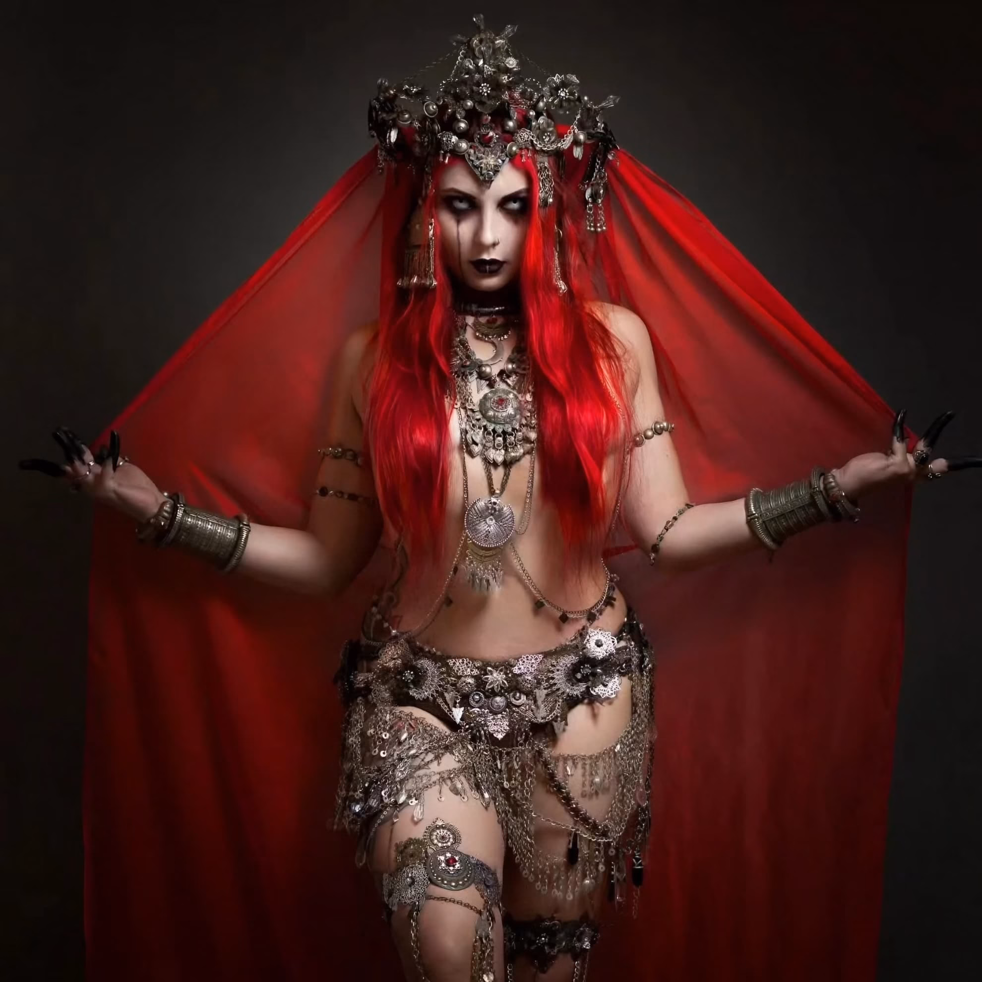Gothla UK Returns to Leicester for a Twentieth Year Ethel AnimA in dark tribal fusion costume with a red veil and layered metalwork.