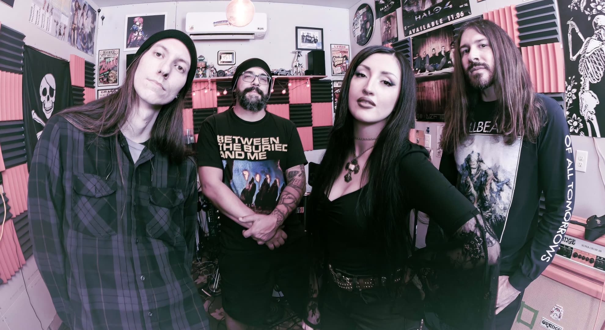 Mothertomb Wring Life From Decay on ‘Dying to Live’ The four members of Mothertomb standing together in a home studio, gathered around vocalist Alice Gawlinski in black.