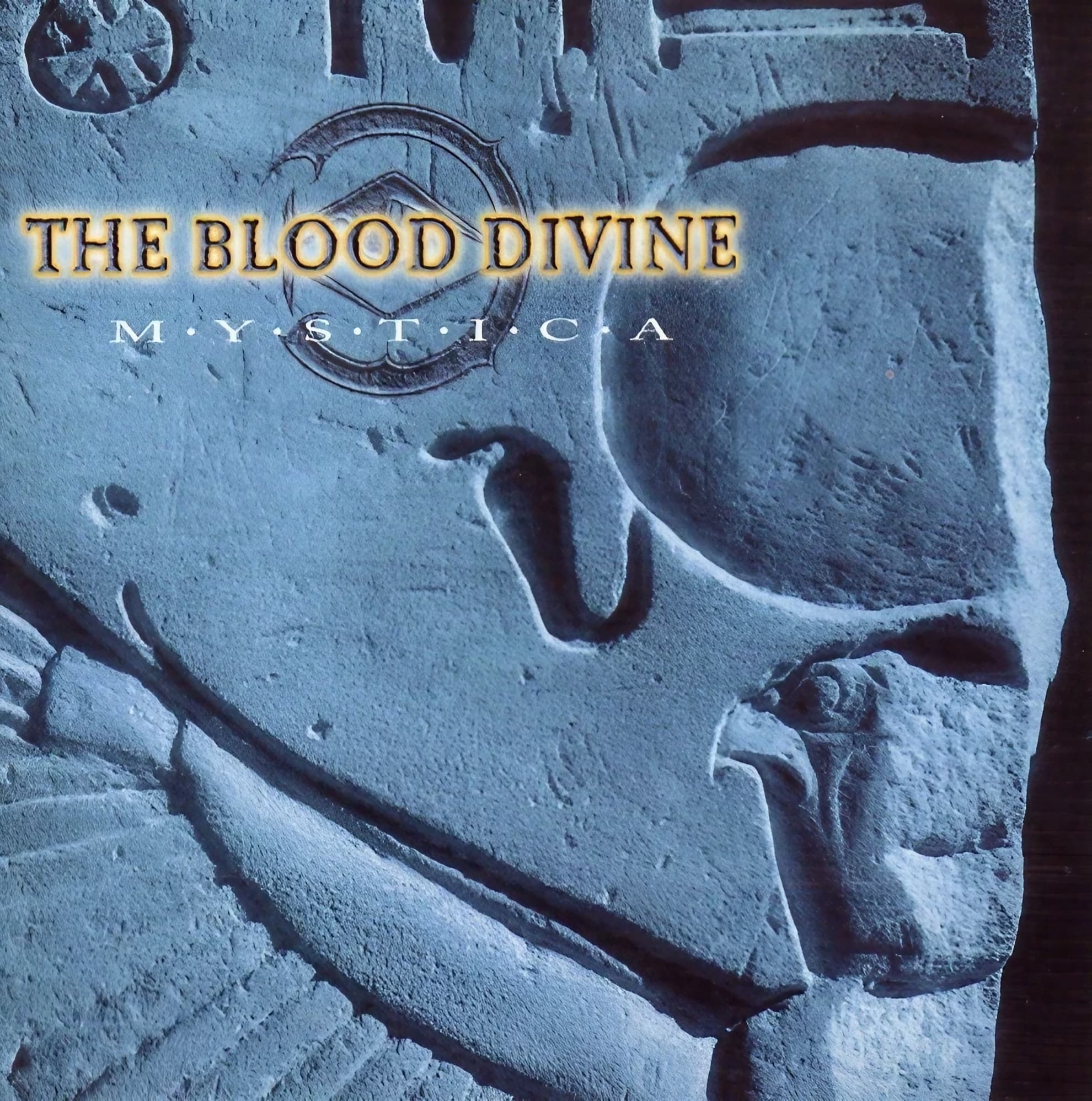 The Blood Divine and the Migration They Could Not Survive The Blood Divine’s 1997 ‘Mystica’ cover, a skull-like stone carving in cold blue tones.