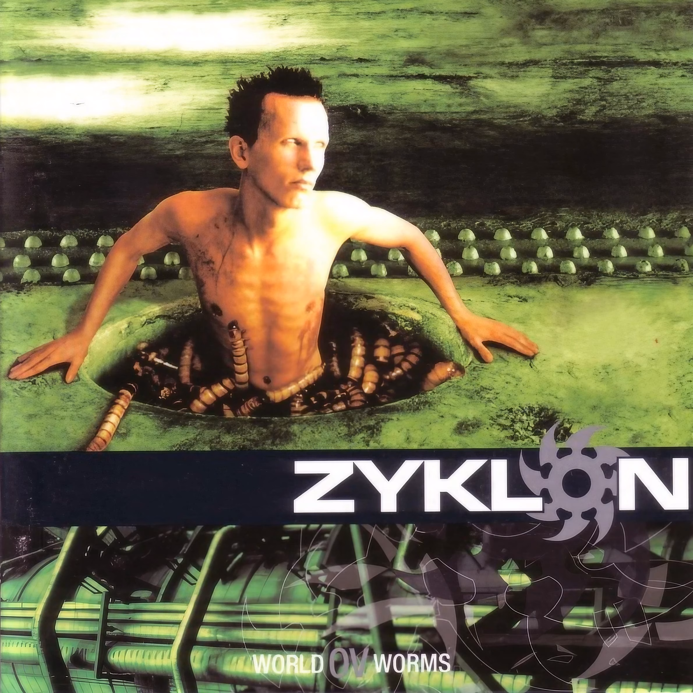 Zyklon and the Machine Inside Norwegian Black Metal ‘World ov Worms’ album cover: a figure emerging from a hole in green, worm-filled biomechanical ground.