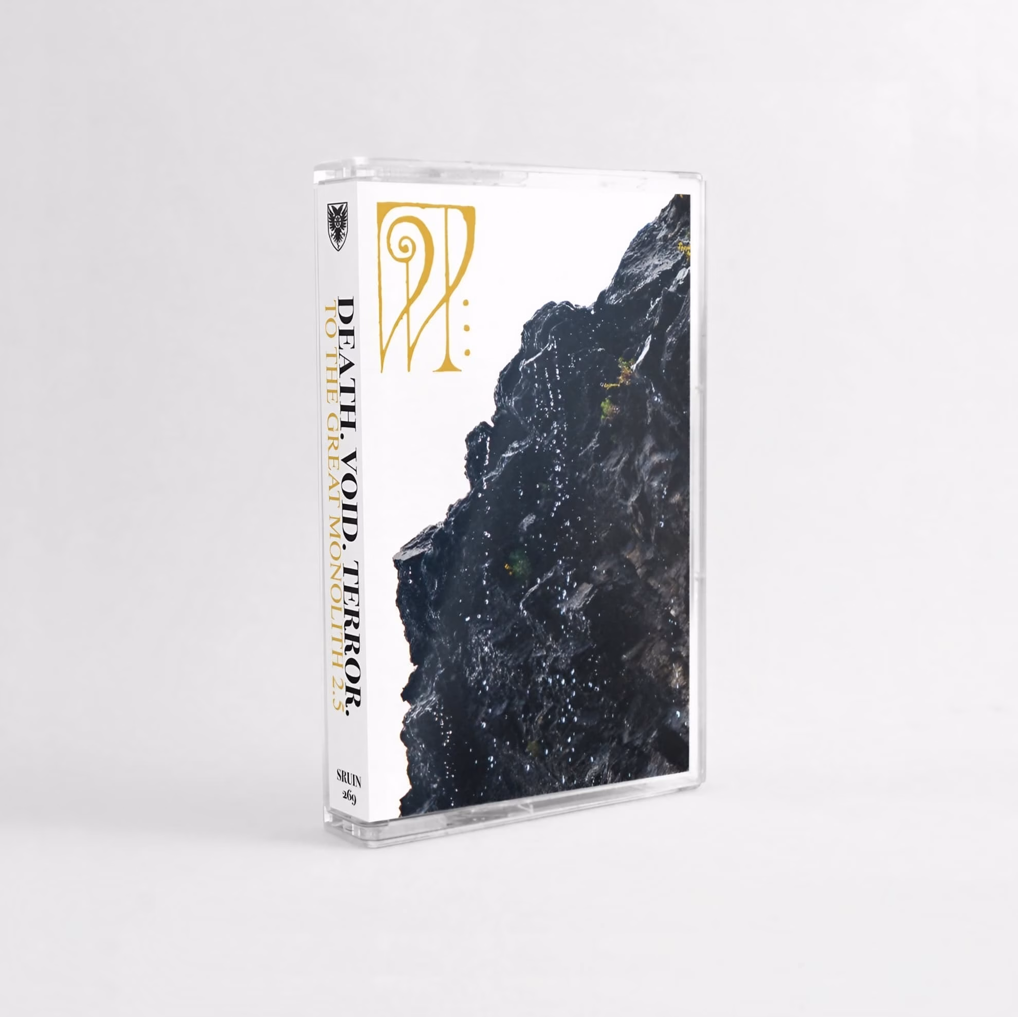 Cassette tape case for Death. Void. Terror.;s ‘To the Great Monolith 2.5,’ shown at an angle against a gray background.