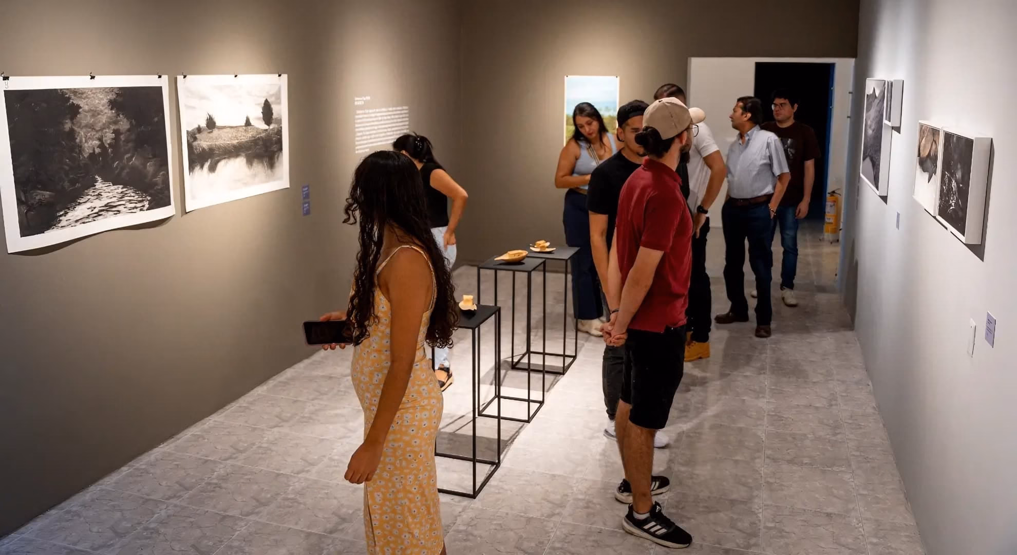 Visitors view charcoal landscape prints during MAT’s four-artist 2026 season opening, Ibagué.