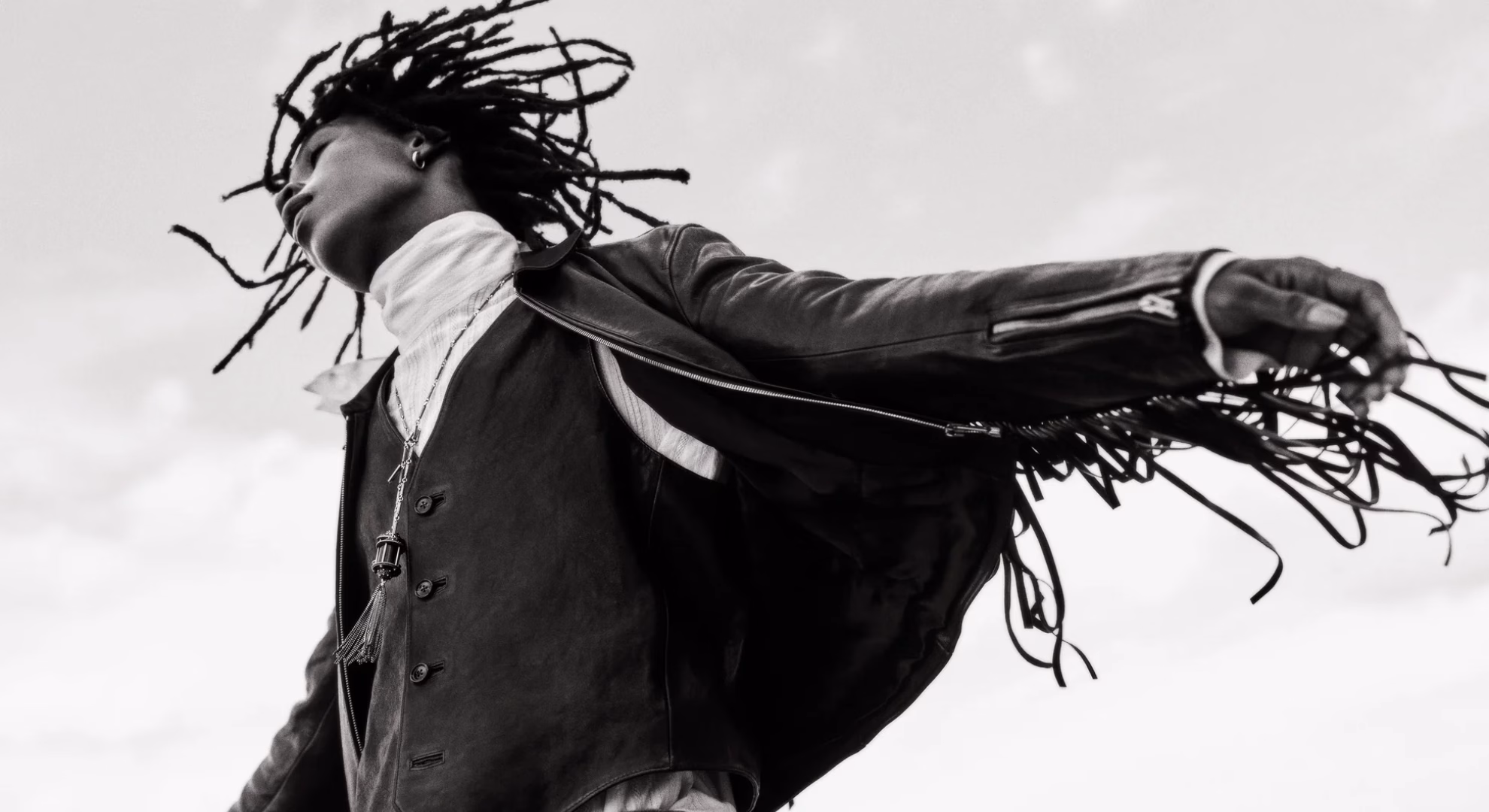 Ann Demeulemeester Carries Its Grief Into a New Century Ezekiel Conteh in a black fringed leather jacket over a buttoned waistcoat, Ann Demeulemeester Fall/Winter 2026.