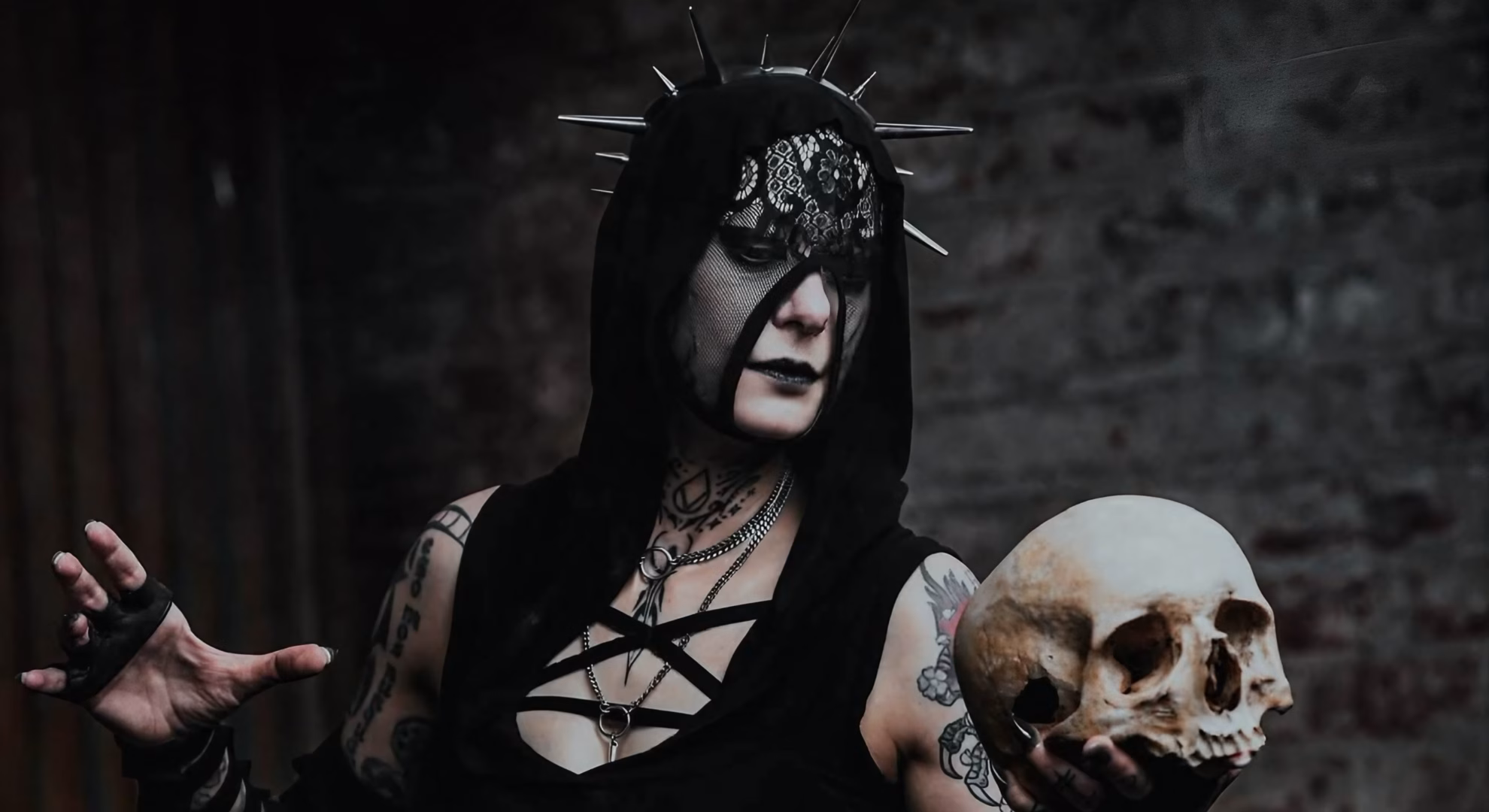 Antania Set Hecate’s Epithet to Machine Rhythm in ‘33’ Antania vocalist Kali Mortem, in a spiked hood and lace eye covering, holds a skull.
