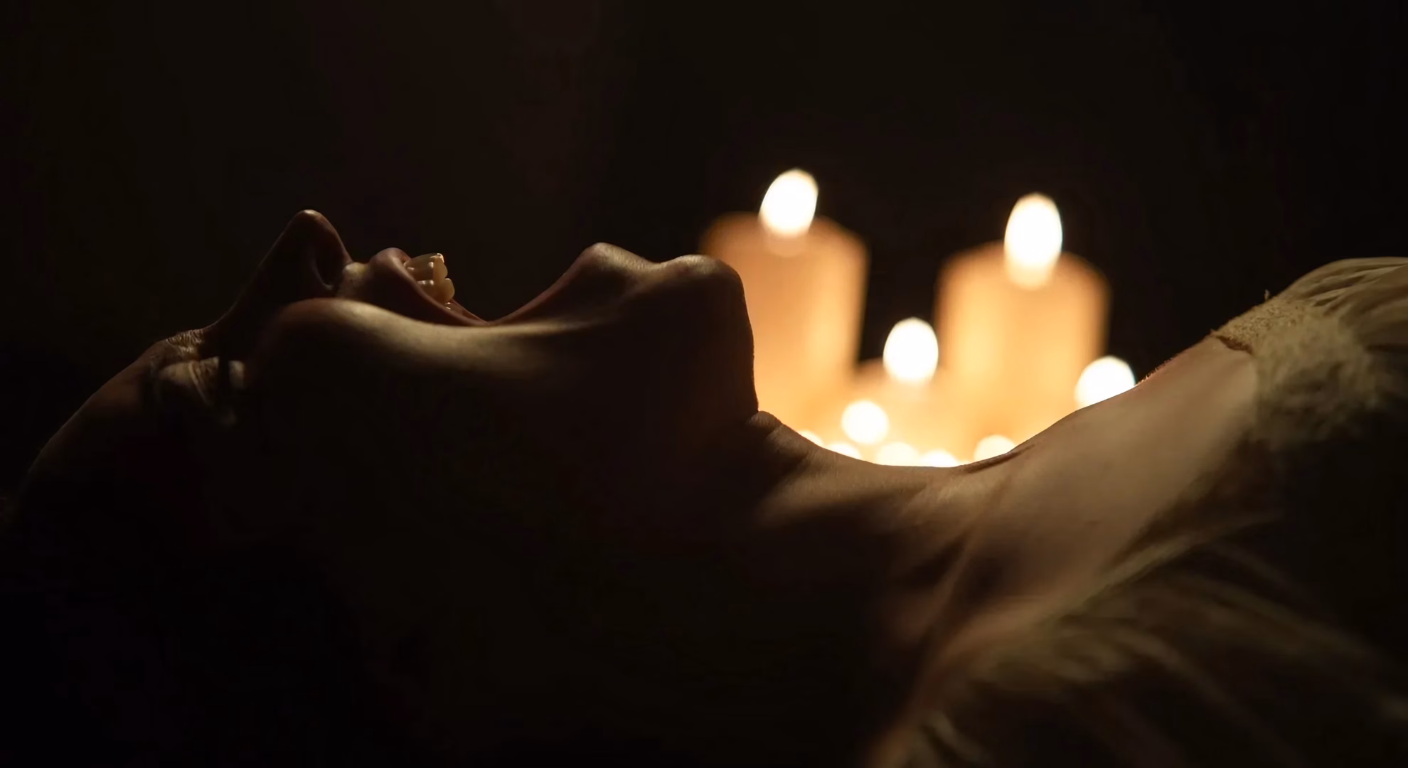 HorrorFest International Becomes Horror’s Closing Stop Close-up silhouette of a character’s face with candlelight blurred behind it, from ‘Goody Goody.’