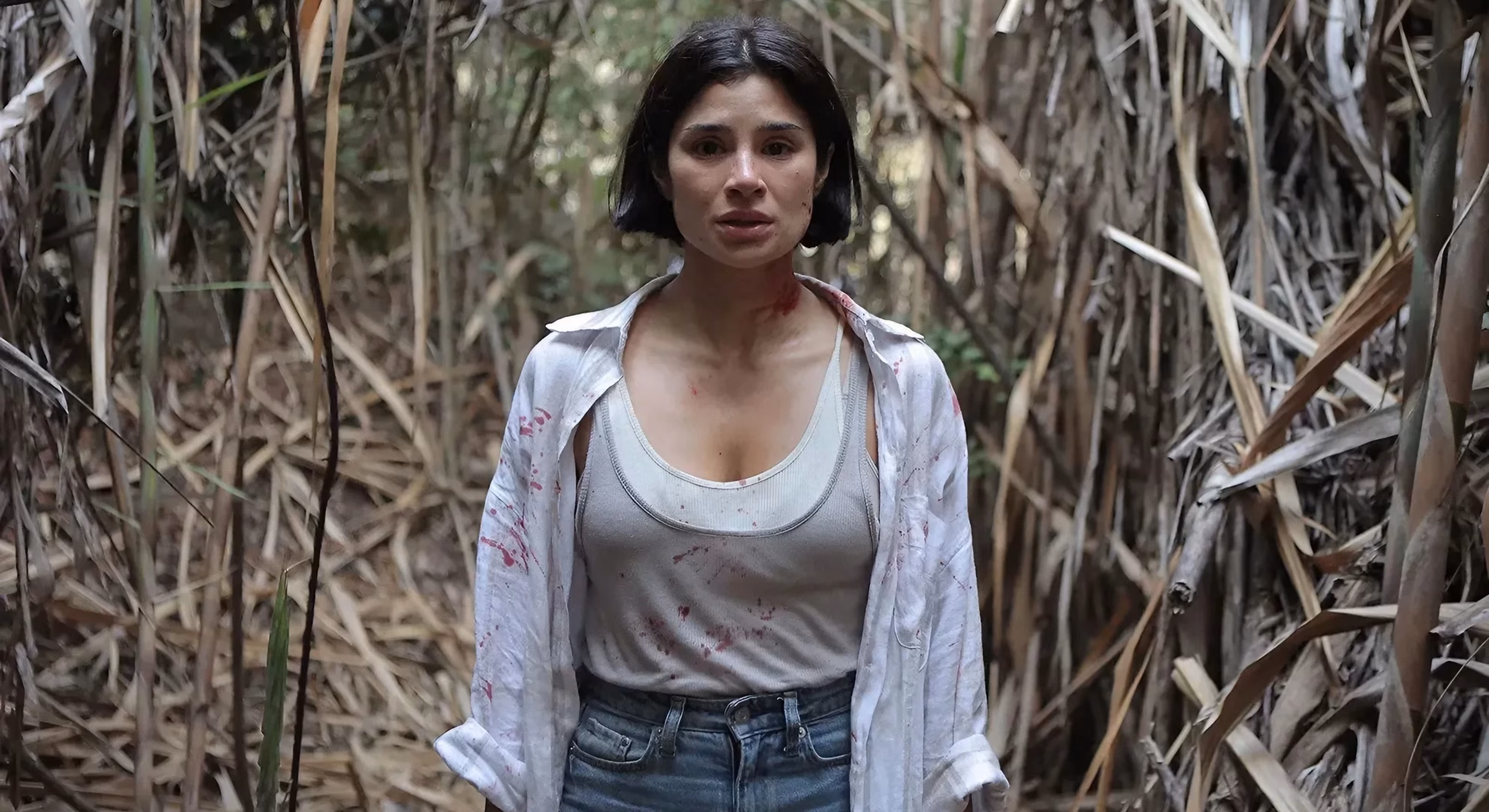 ‘Poseído’: Nicole (Diane Guerrero) stands blood-marked in dry Llanos cane.
