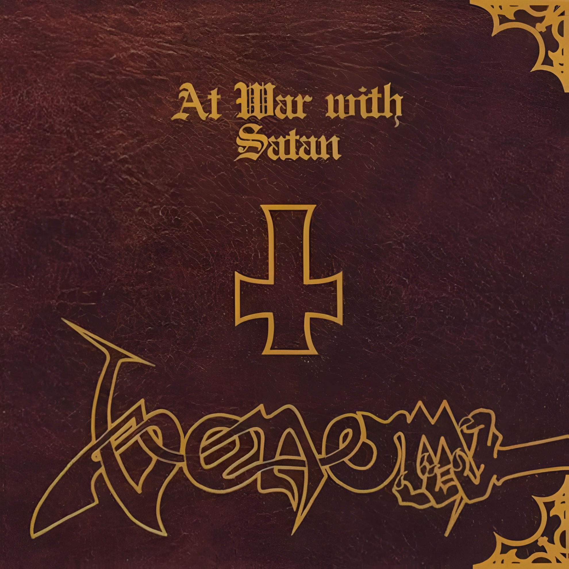Conrad “Cronos” Lant Sang as the Devil, Not About Him Album cover of ‘At War with Satan’ by Venom, styled as a worn leather book with a gold gothic title, an inverted cross, and the band logo below.